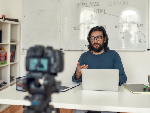 Man sitting at desk self recording