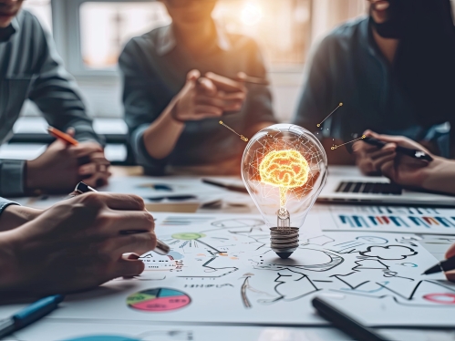 idea light bulb in center of group sitting at table