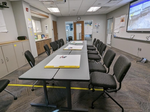 classroom space with large desk and chairs